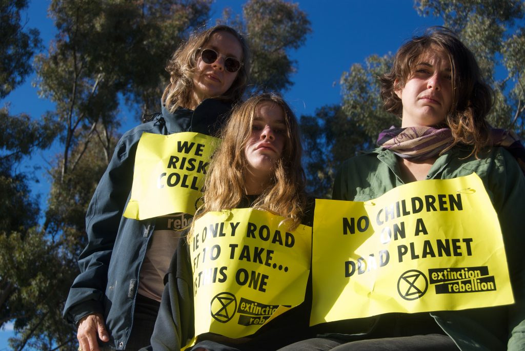 committed climate activists Anthea, Mary and Violet with Extinction rebellion protest