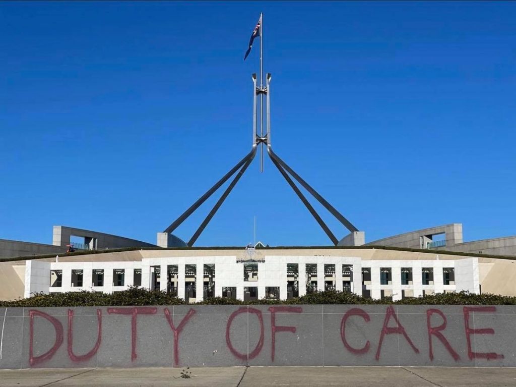 Graffiti on wall at Canberra house in Canberra reminding our government that they have a duty of care in the climate emergency facing the world