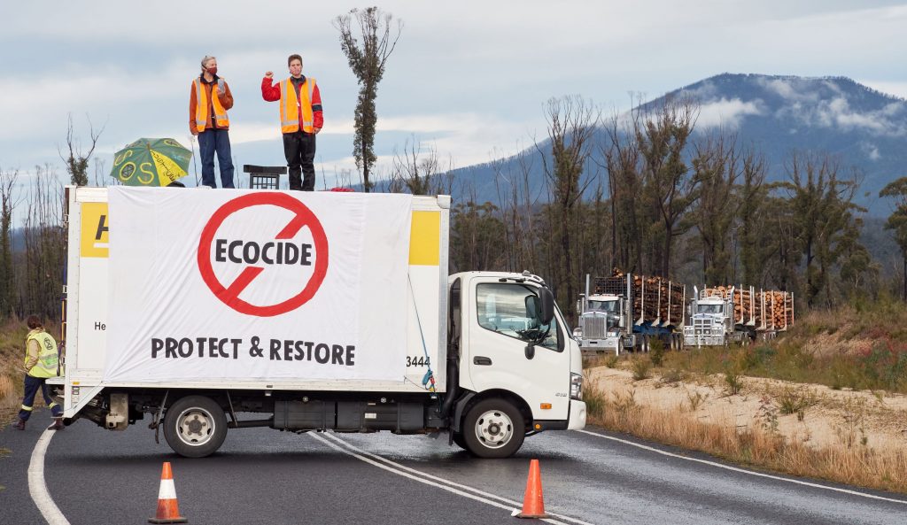 Bega Valley XR Extinction members blocking access for logging trucks transporting native forest trees to the Eden chip mill
