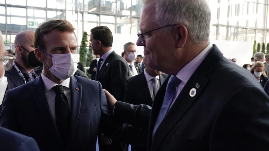 A photo of Scott Morrison and Emmanuel Macron discussing failed submarine deal
