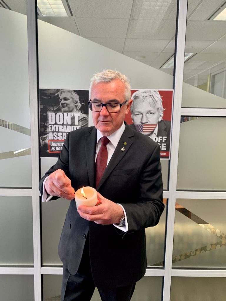 Australian independent politician Mr Andrew Wilkie showing his support for political prisoner Julian Assange by lighting a candle. 
