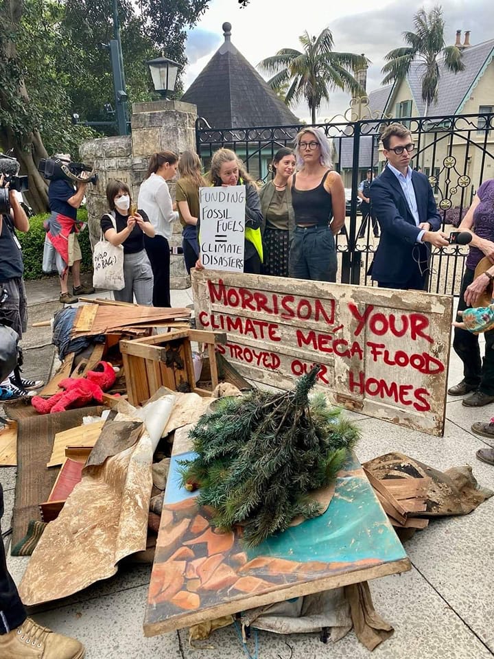 Flood affected people from Lismore dump remains of their homes on Scott Morrison's front door, March 2022. 