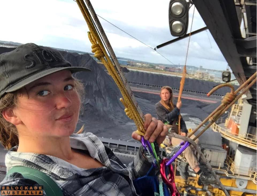 Two Blockade Australia activists abseiling off a stacker-reclaimer and stopping all operations at the Newcastle Coal Port in Muloobinba.