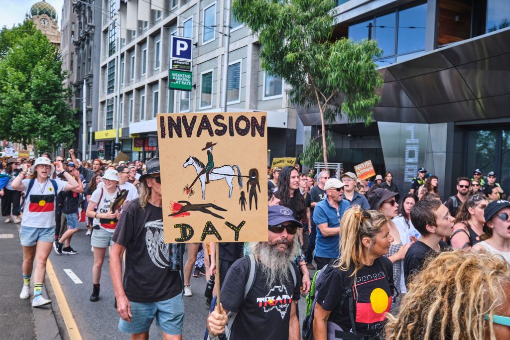 The history of colonialism and associated genocides cannot be denied. Protest march on Australia Day, 26 January 2020 in Melbourne. The protesters carry signs callin 26 January Invasion Day.