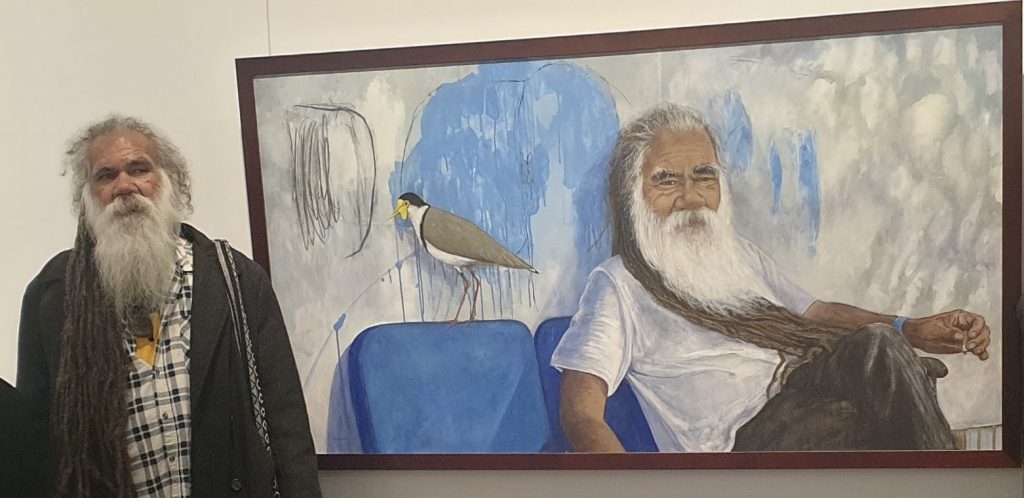 Wreck Bay elder and artist Uncle Tom Brown at the opening of ......."inspired by nature and humanity" at the Jervis Bay Maritime Museum and Gallery. The painting titled Uncle Tom Brown is one of two portraits of Randall's show.