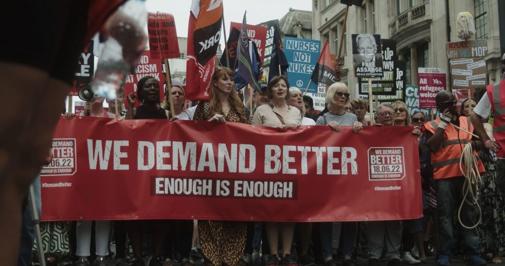 Thousands of trade unionists travelled from across the UK to march through central London calling for government action on the cost of living crisis and the impact rising costs are having on working people, June 2022. The rally banner reads We Demand Better.