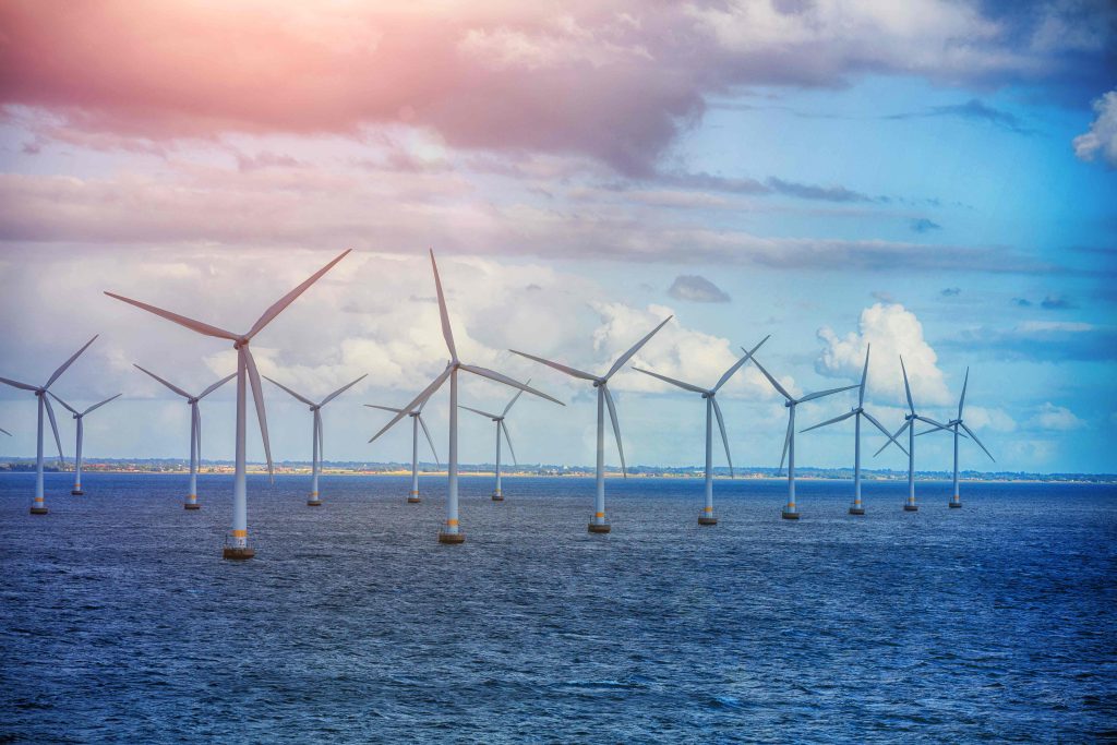 A row of floating offshore wind turbines